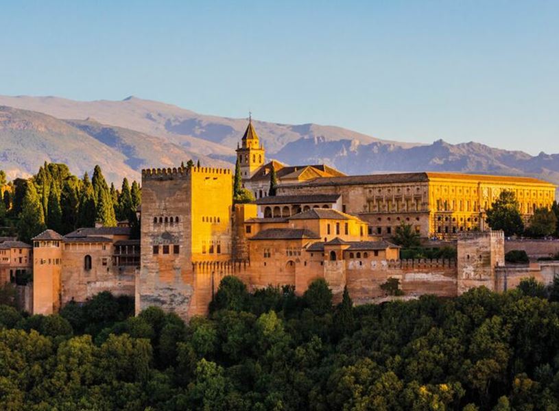 The Alhambra fortress and Sierra Nevada mountains at sunset, Granada, Spain