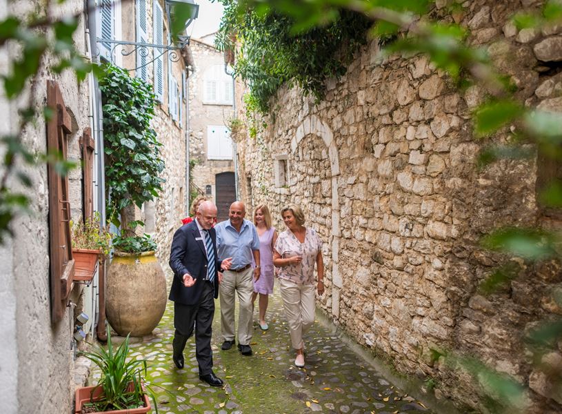 Guests walking down an old traditional street in St Paul de Vence, France