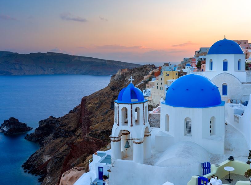 Dusk over blue domed churches on Santorini, Greece