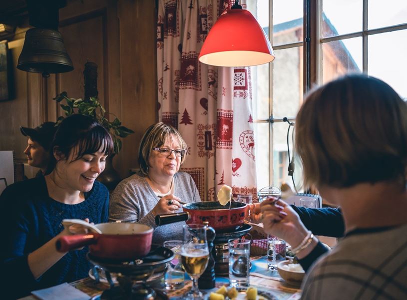 Guest enjoying a raclette dinner, Grenoble, France