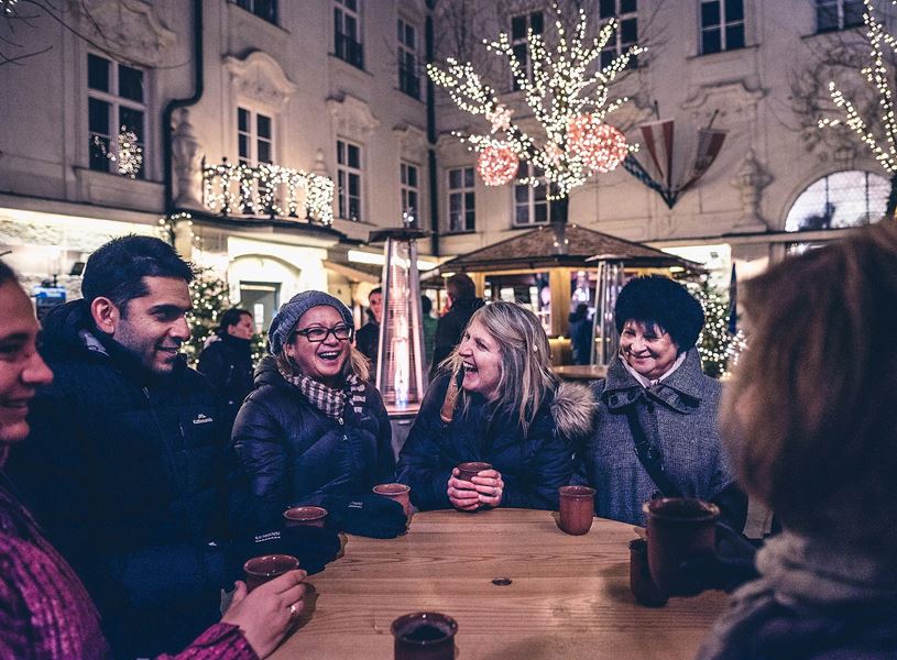 Travellers enjoying Gluhwein at the Christmas market in Salzburg, Austria​