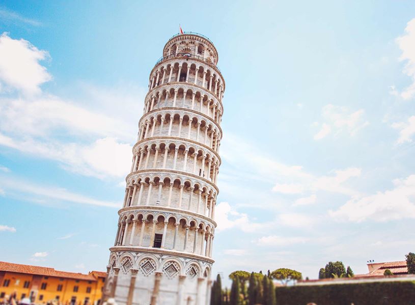 Leaning Tower of Pisa with surrounding buildings and trees 