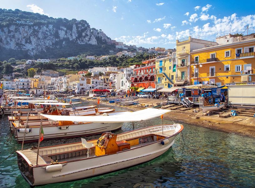 Marina Grande harbour in Capri with colourful buildings and moored fishing boats