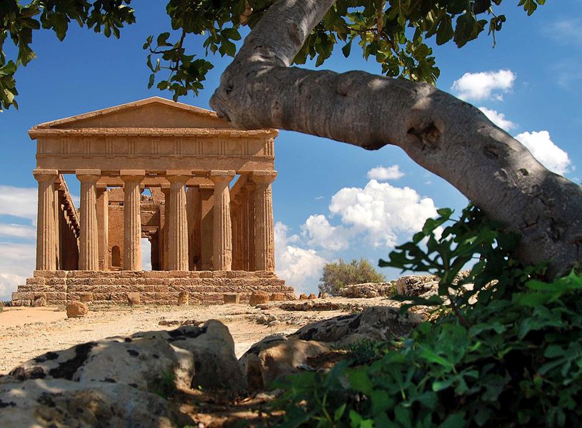 Temple of Concordia ancient Greek structure framed by tree branch in Agrigento