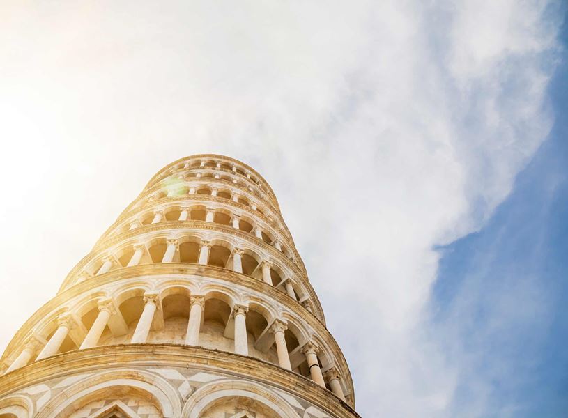 Leaning Tower of Pisa viewed from low angle with cloudy sky