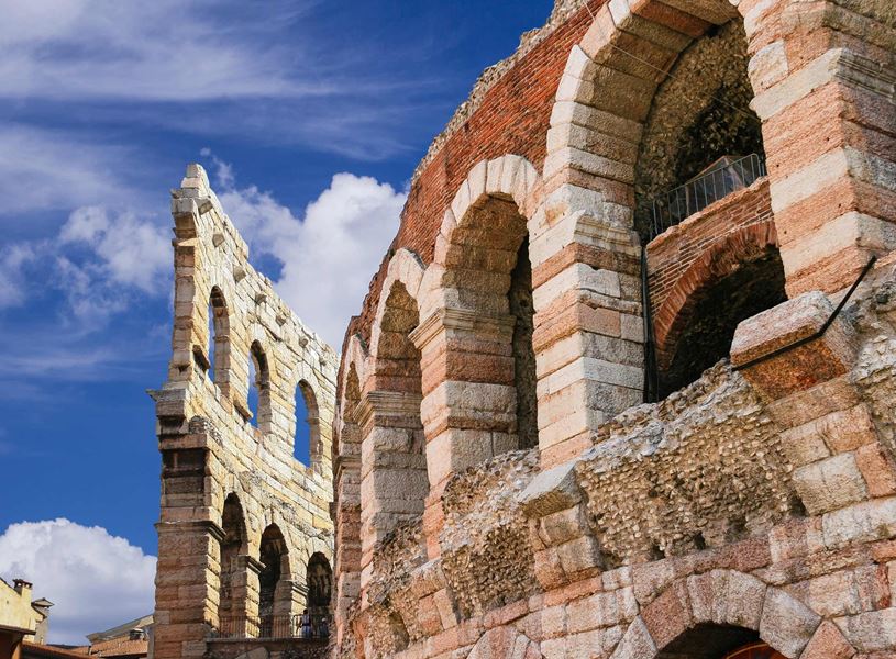 Close-up of Verona Arena ancient Roman amphitheatre with stone arches and partially preserved wall