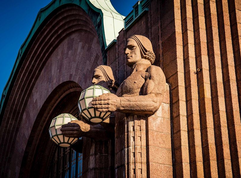 Lantern Bearers statues on Helsinki Central Railway Station facade in Finland