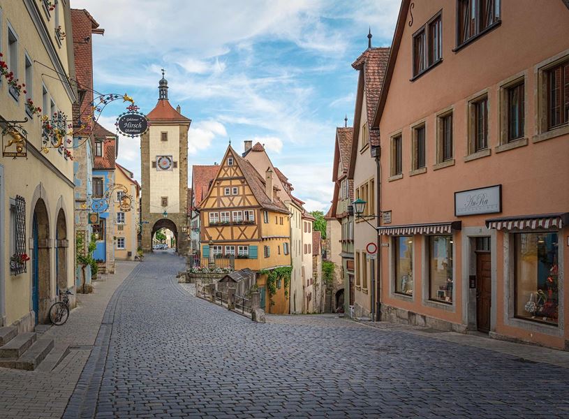 Street with colourful buildings and tower gate in Rothenburg ob der Tauber