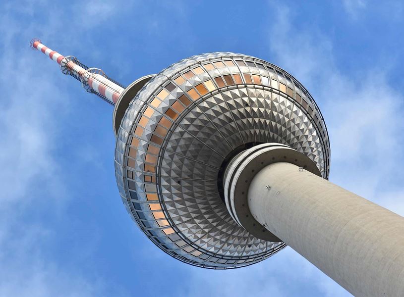 Berlin TV Tower close-up with sphere and antenna against blue sky