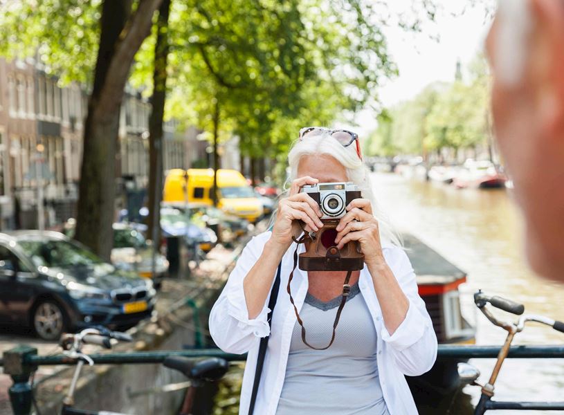 Woman and man with camera taking picture in Amsterdam, Netherlands
