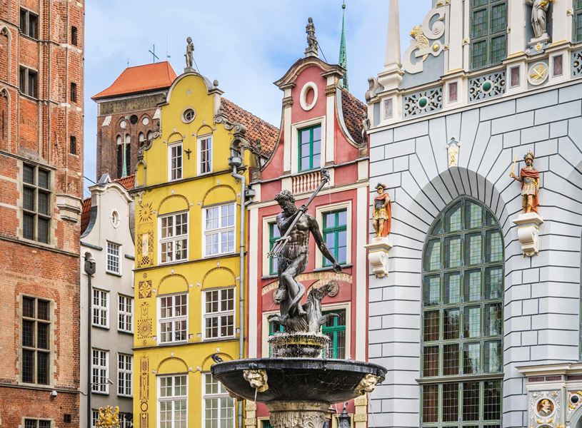 Neptune Fountain in Gdańsk Old Town with colourful buildings 