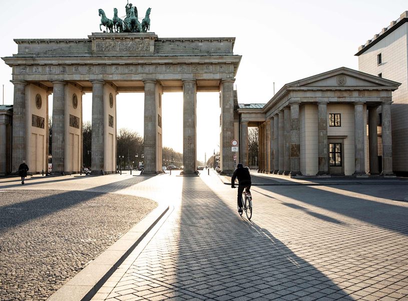 Brandenburg Gate with cyclist and pedestrian in Berlin, Germany