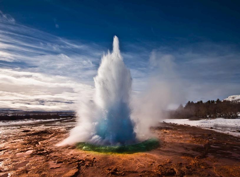 Geysir hot spring erupting with steam and water in Iceland