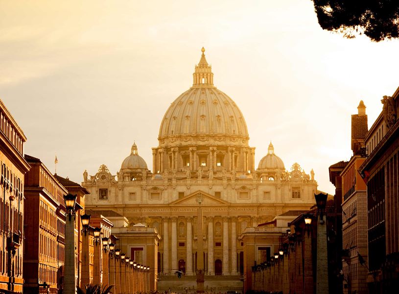 St. Peter’s Basilica in Vatican City at sunset viewed from Via della Conciliazione street