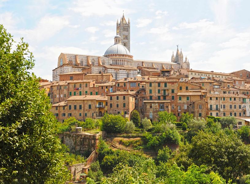 Panoramic view of Siena with Siena Cathedral dome and bell tower rising above buildings