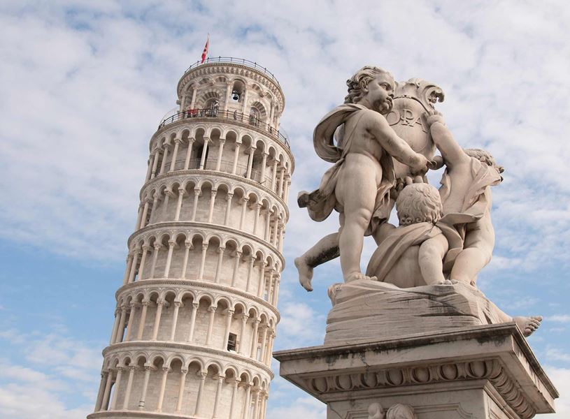 Leaning Tower of Pisa with marble cherub statue in foreground under partly cloudy sky