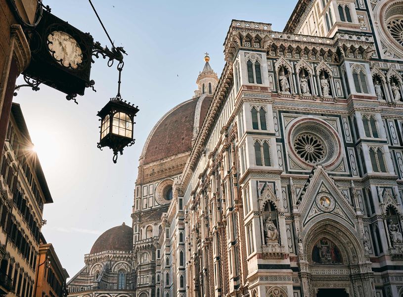 Close-up view of Florence Cathedral’s facade and street lamp