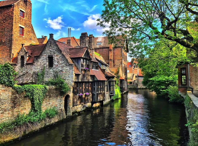Scenic view of canal with medieval buildings in Bruges, Belgium