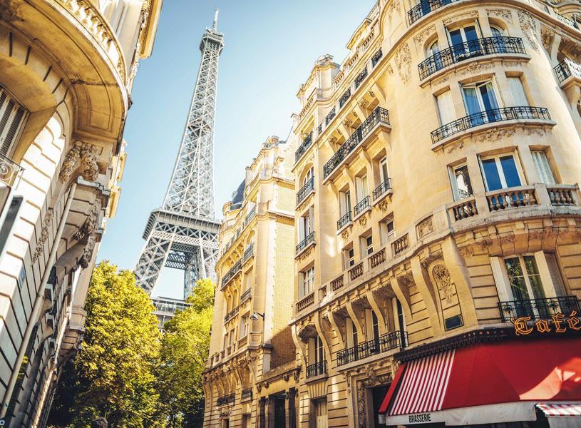 Eiffel Tower viewed from Paris street with classic buildings