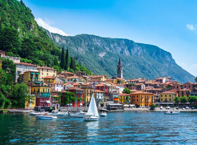 Colourful Varenna village on Lake Como with boats and mountain backdrop