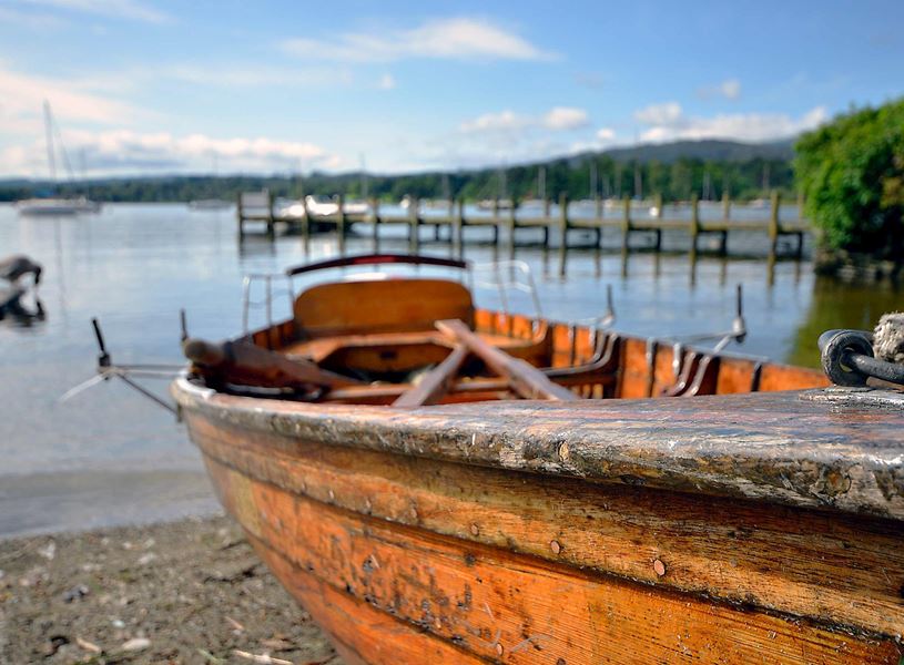 Wooden Boat near Lake Windermere with dock in England