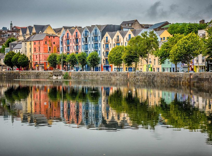 Colourful waterfront buildings reflected in the waters of the River Lee in Cork, Ireland