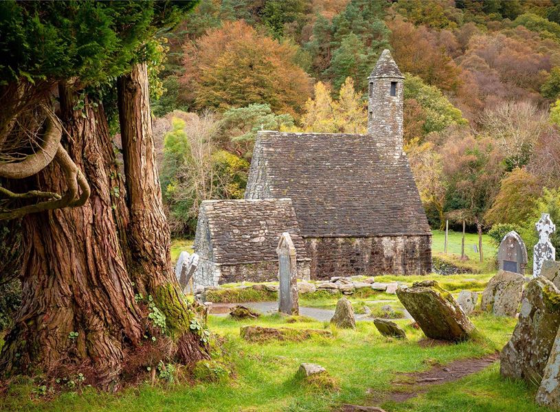 Monastic ruins at Glendalough with round tower and graveyard