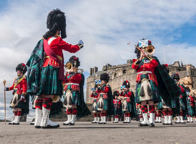 Scottish marching band in traditional uniforms performing outside Edinburgh Castle, Scotland