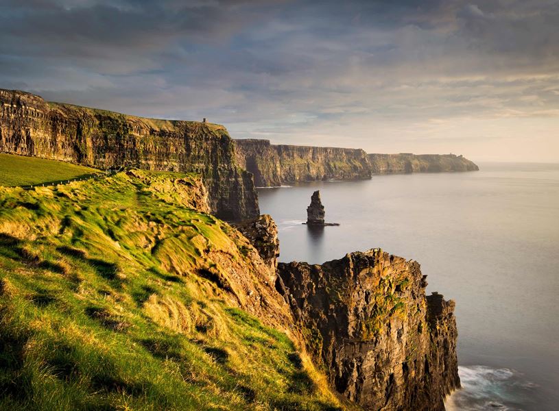Cliffs of Moher with sea stack, grassy edge and Atlantic Ocean view