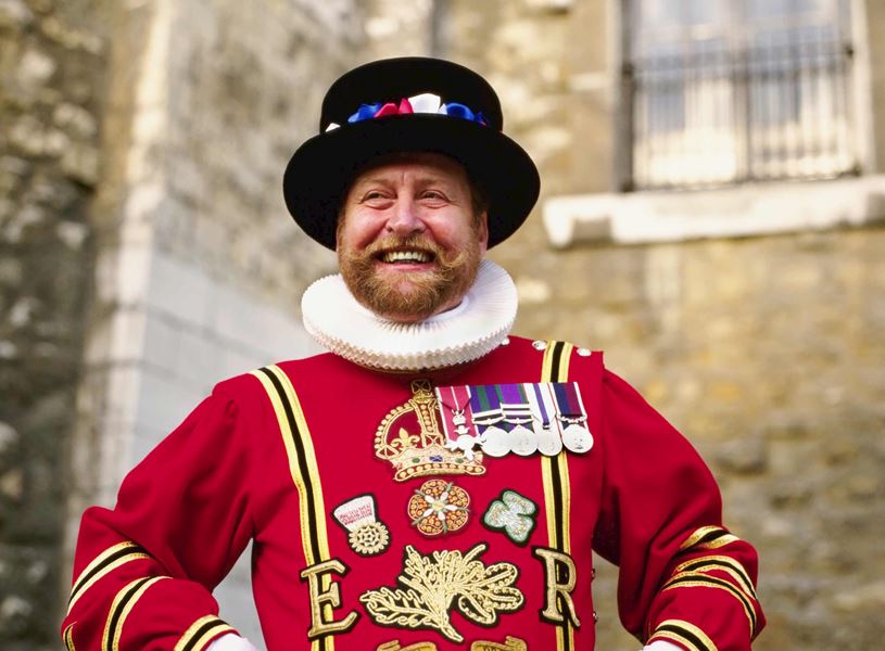 Smiling Beefeater in uniform at Tower of London, England