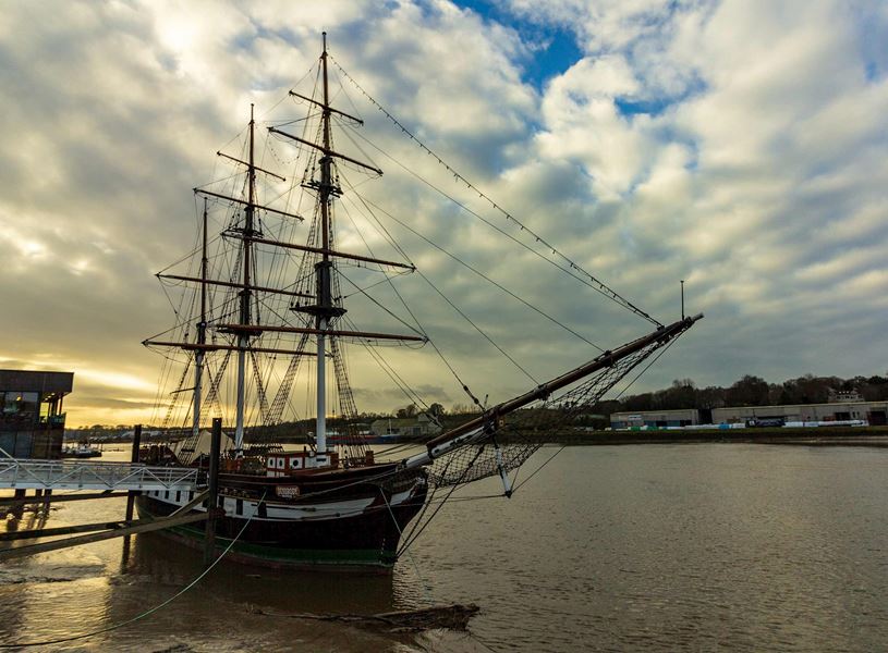 Dunbrody Famine Ship docked on River Barrow under cloudy sky in New Ross 