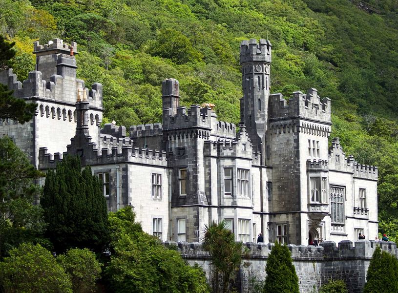 Kylemore Abbey’s neo-Gothic castle facade set against green hill