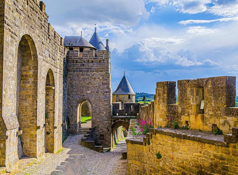 Carcassonne fortress with towers, battlements and cobblestone path in France
