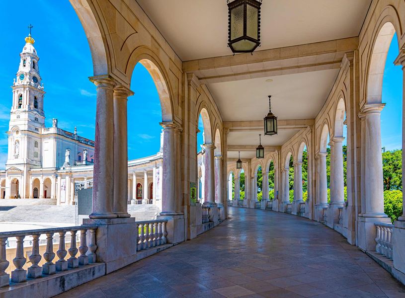 Sanctuary of Fátima basilica viewed through arched colonnade in Portugal