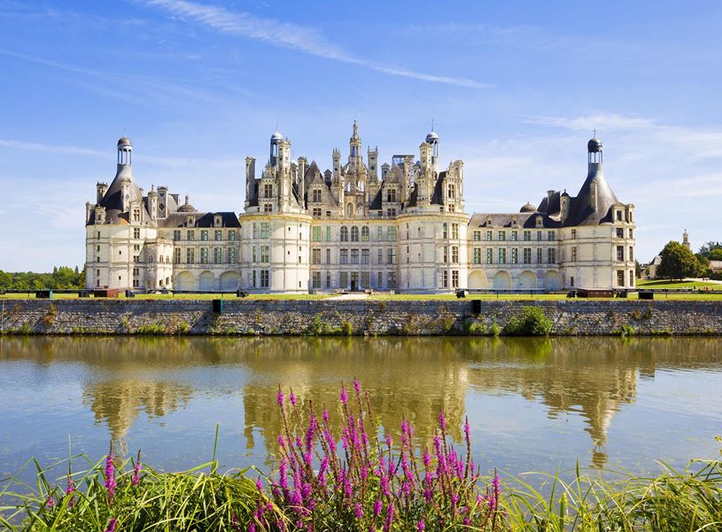 Château de Chambord with spires mirrored in water in France