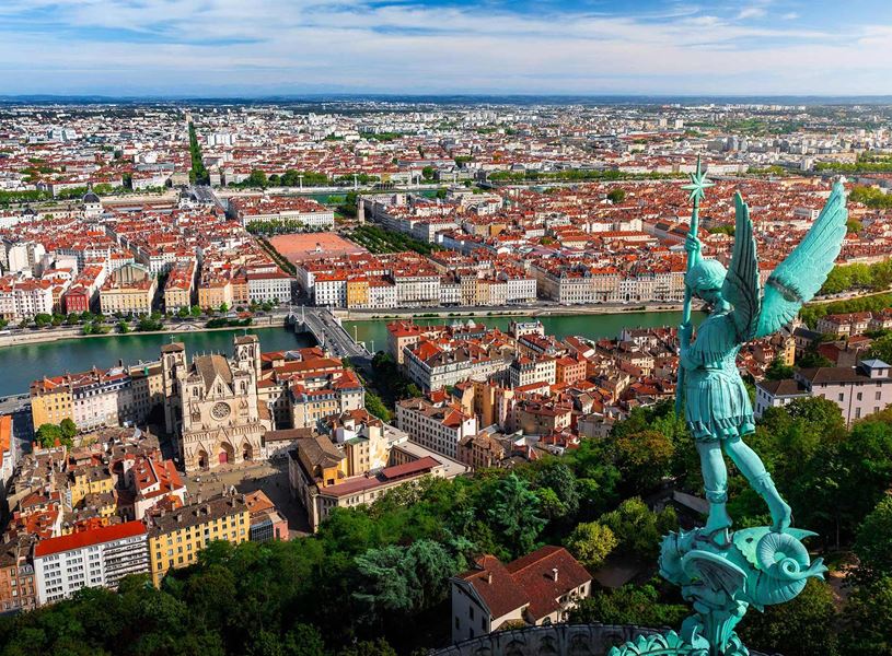 Lyon cityscape with Archangel Michael statue and Saône River