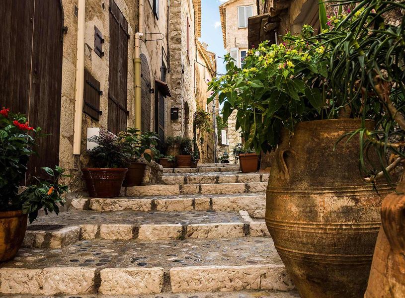 Stone alley with steps, flowers and buildings in Saint Paul De Vence, France