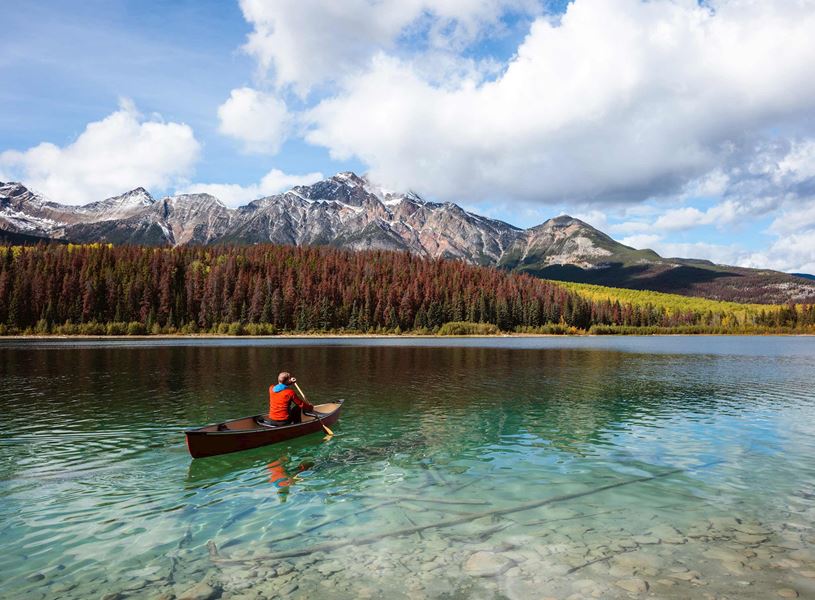 Man Canoeing on Lake in Jasper, Canada