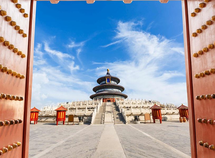 View through the red gates toward the ancient sacrificial temple at the Temple of Heaven in Beijing, China