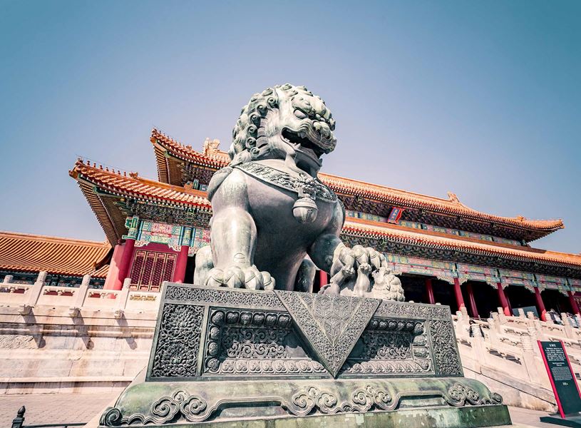 Bronze lion statue guarding an entrance in the Forbidden City, Beijing, China