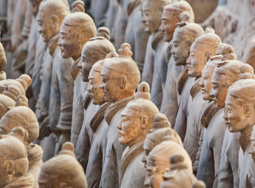 Rows of sunlit terracotta army warriors, Xian, China