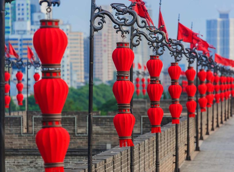 ld Town wall featuring hanging red lanterns and flags, Xi’an, China