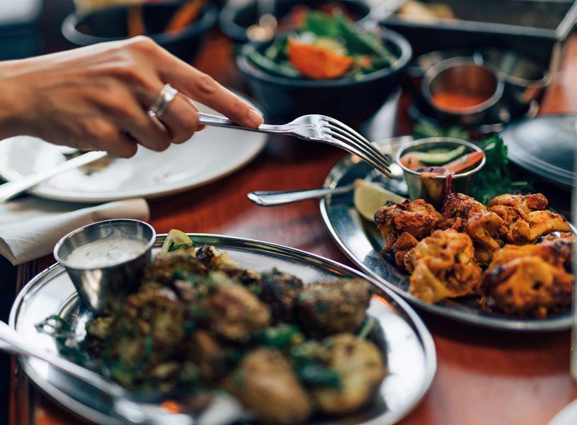 Close up of Chicken Tikka eaten with fork in Delhi, India