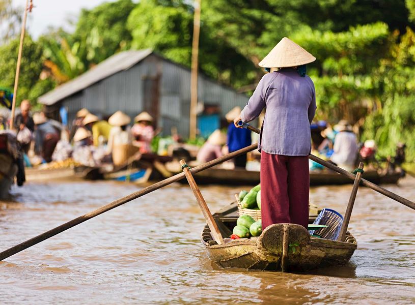 Woman on rowing boat in Mekong Delta, Vietnam