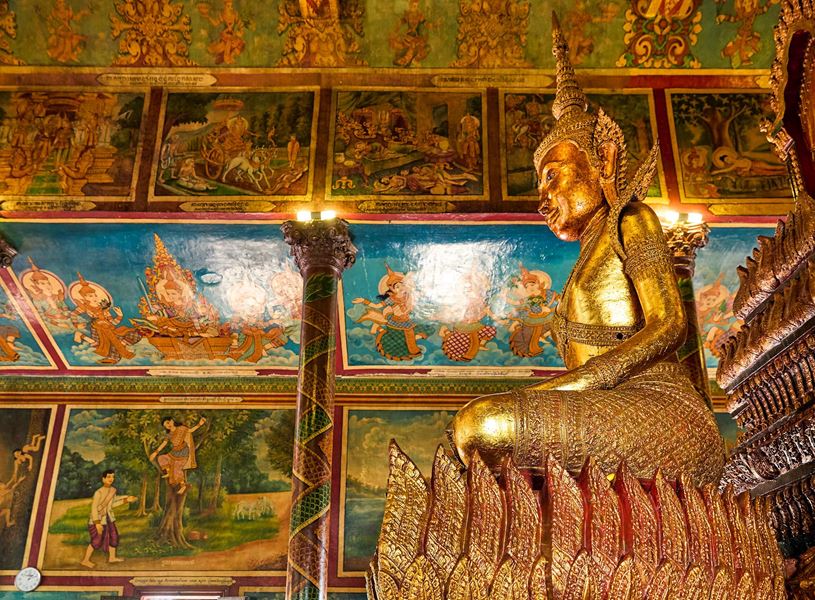 Wat Phnom Temple interior with golden statue in Phnom Penh, Cambodia