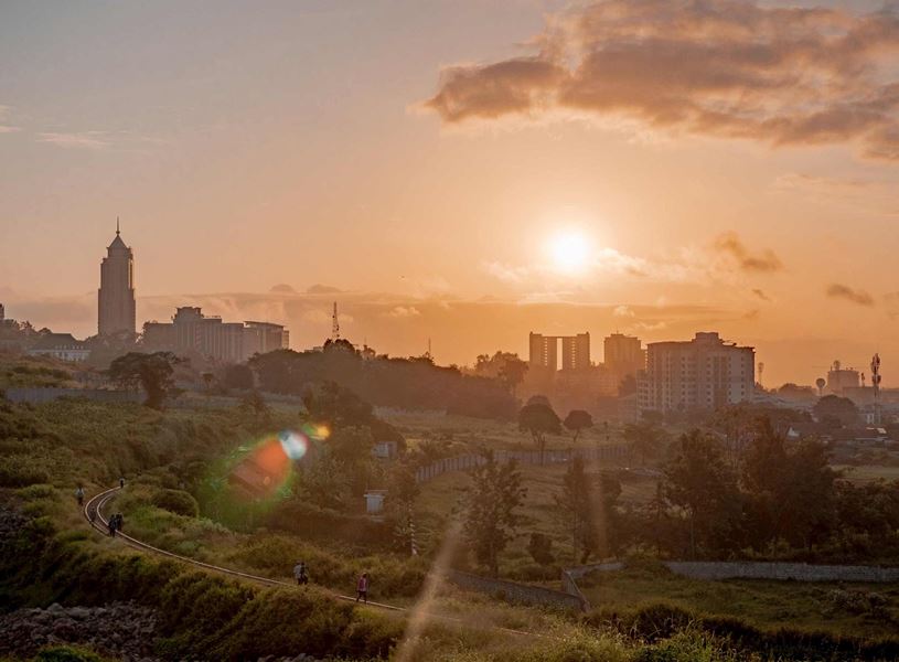 Nairobi cityscape with green park in foreground at sunset, Kenya