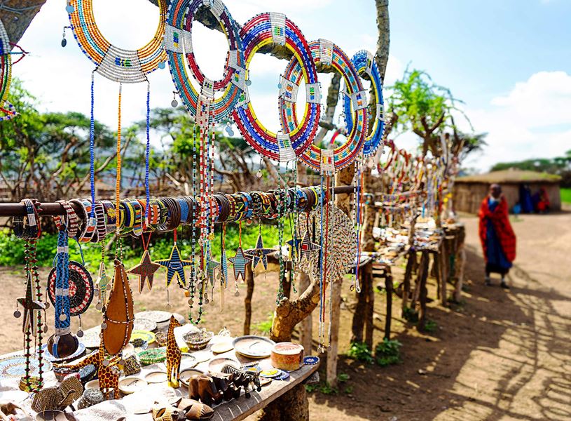 Traditional jewellery and colourful souvenirs displayed at a stall, Maasai Mara, Kenya