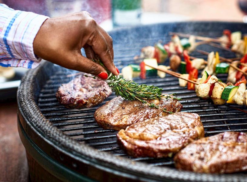 A person cooking meat on the barbeque in Mbabane, Eswatini, Africa