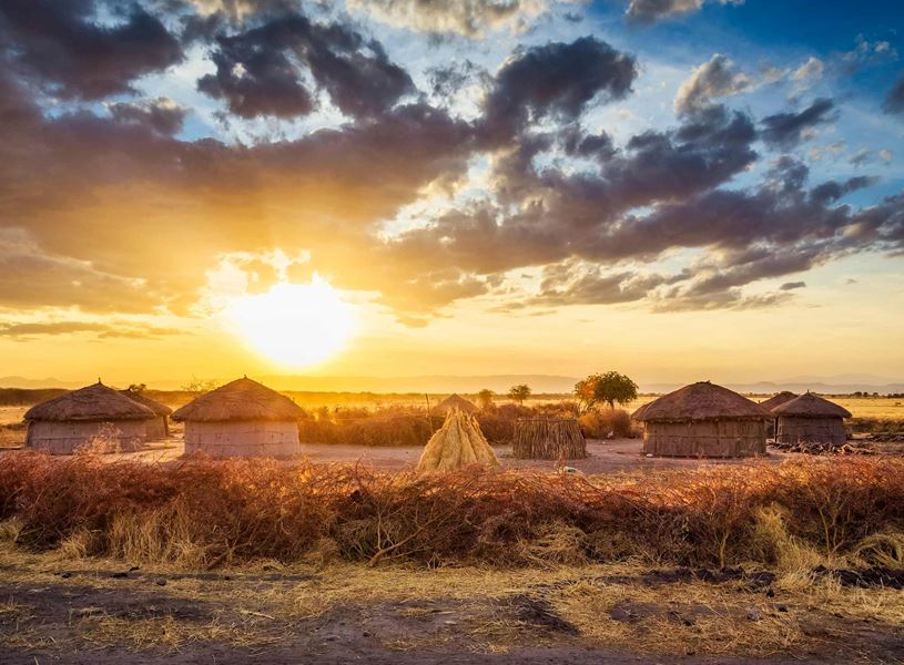 Traditional village huts in soft golden light, Tarangire National Park, Tanzania