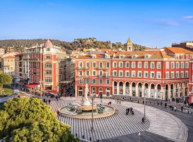 Aerial view of Place Masséna with red buildings and fountain in Nice, France